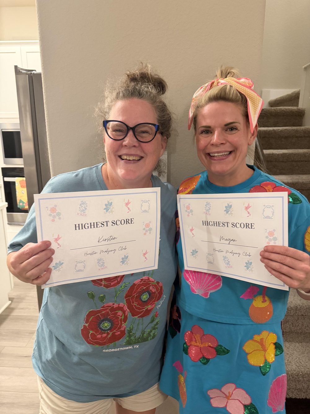 Kirsten and Megan smiling together, holding their Highest Score certificates
